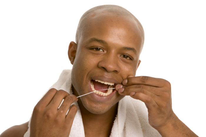 Person flossing his teeth